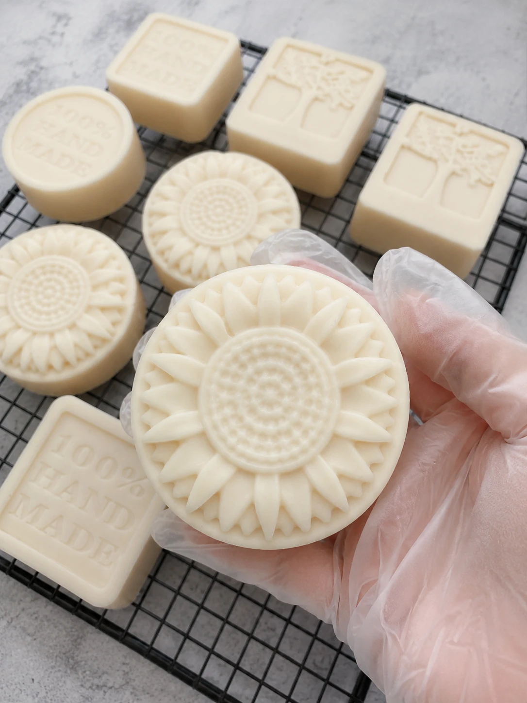 Cold process soap making in small batches — hand-poured goat milk honey soap bars curing on racks