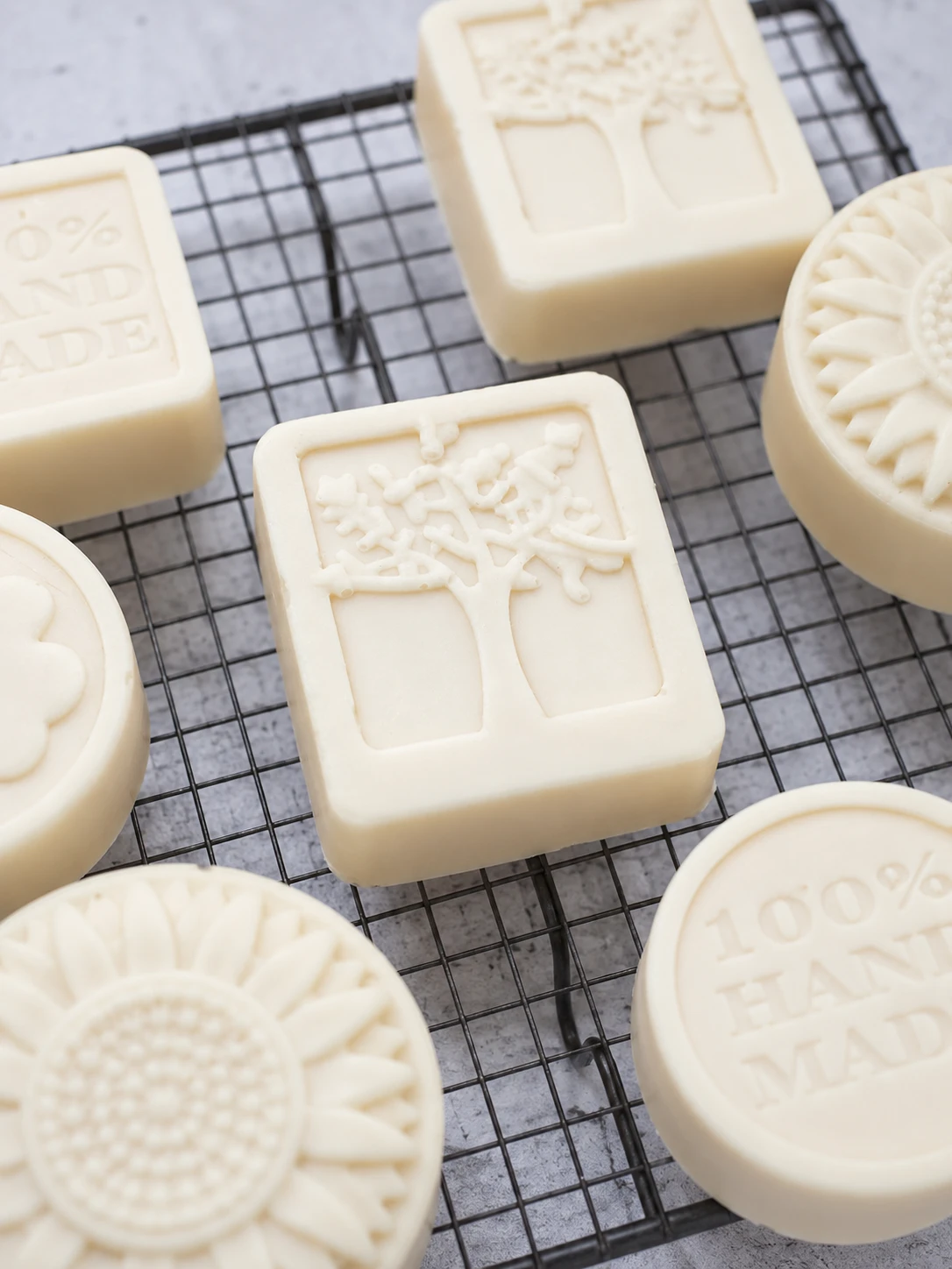 Goat milk honey soap with complementary bath accessories — exfoliating mitt, wooden soap dish, and body butter