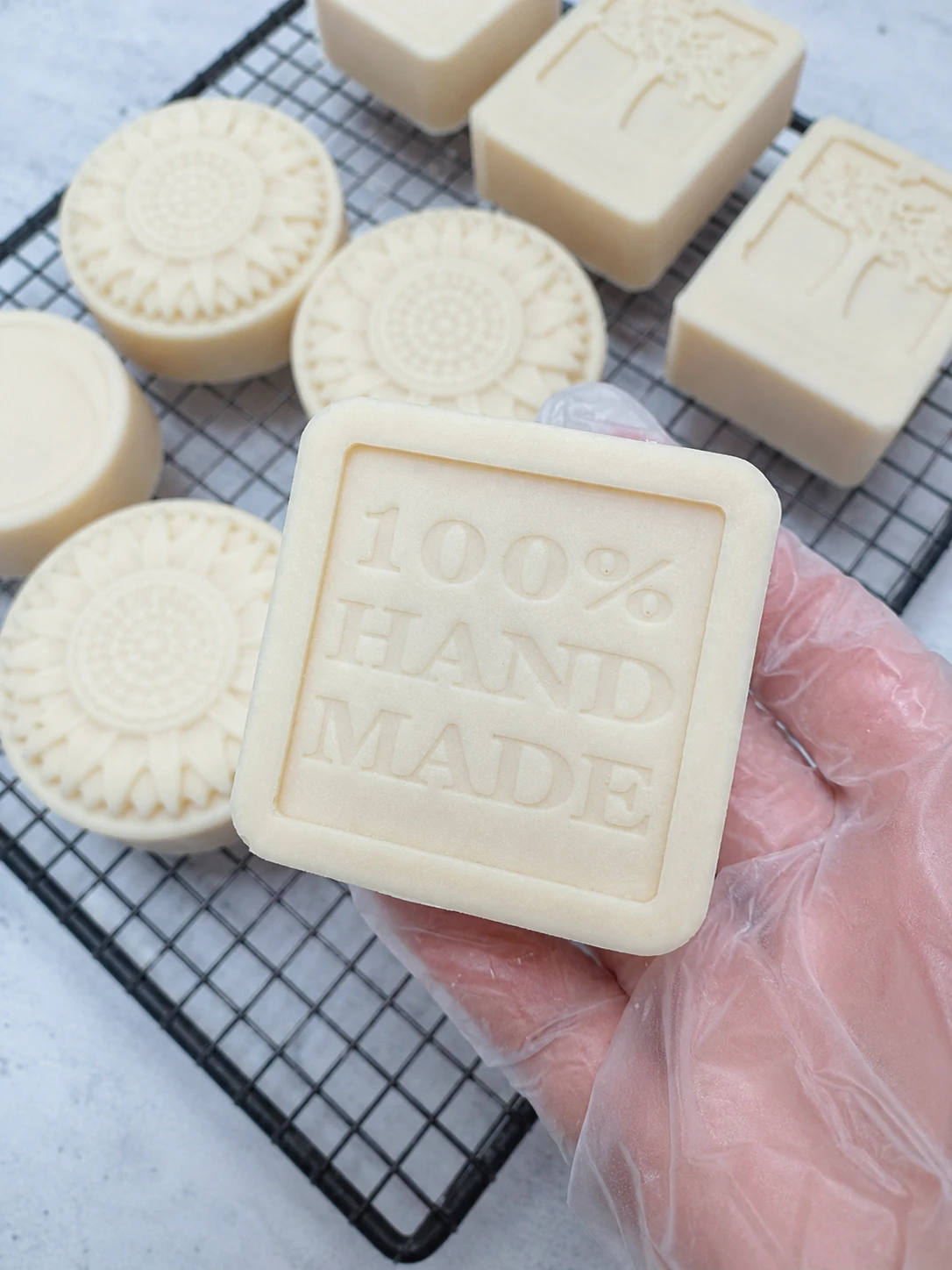Handcrafted goat milk honey soap bar with creamy lather on rustic wooden surface